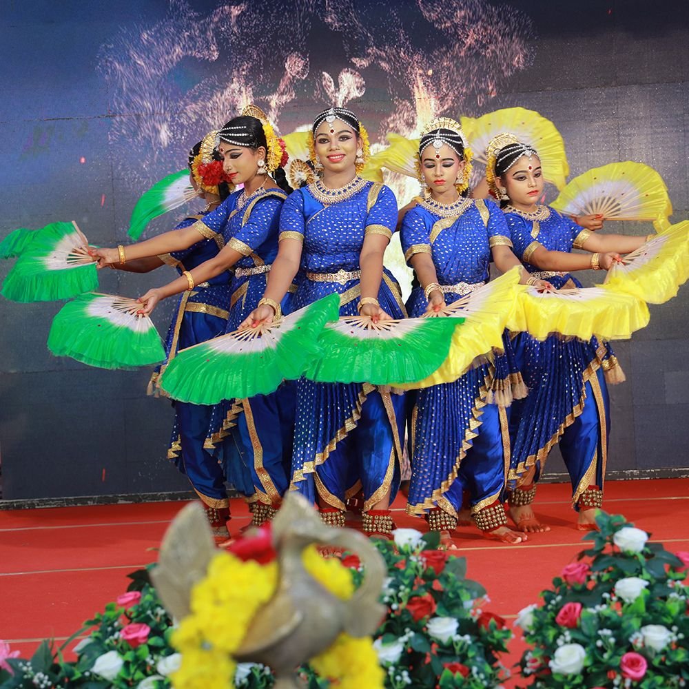 Students performing a classical dance item on stage